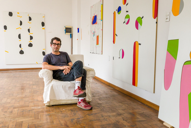 Alexandre Canonico sitting in front of selected works.