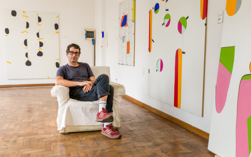 Alexandre Canonico sitting in front of selected works.